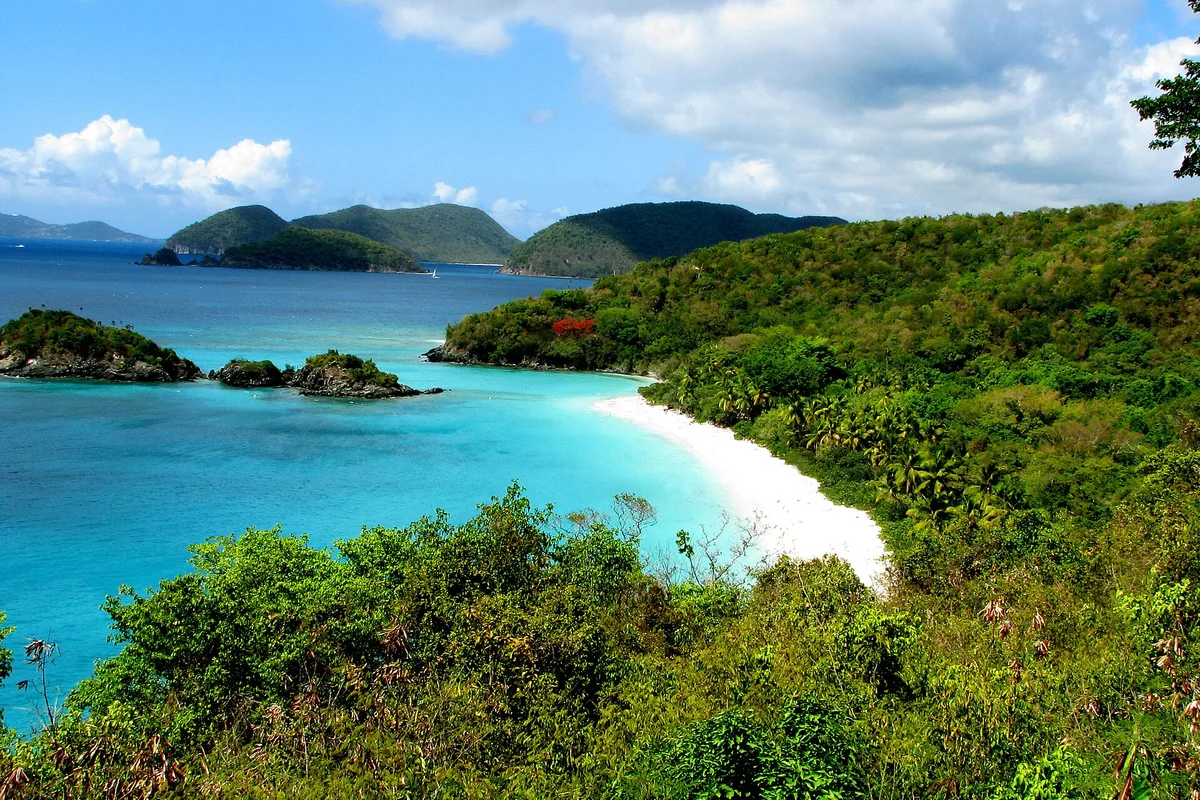 Trunk Bay on St. John, white sand curving below green hills and offshore cays