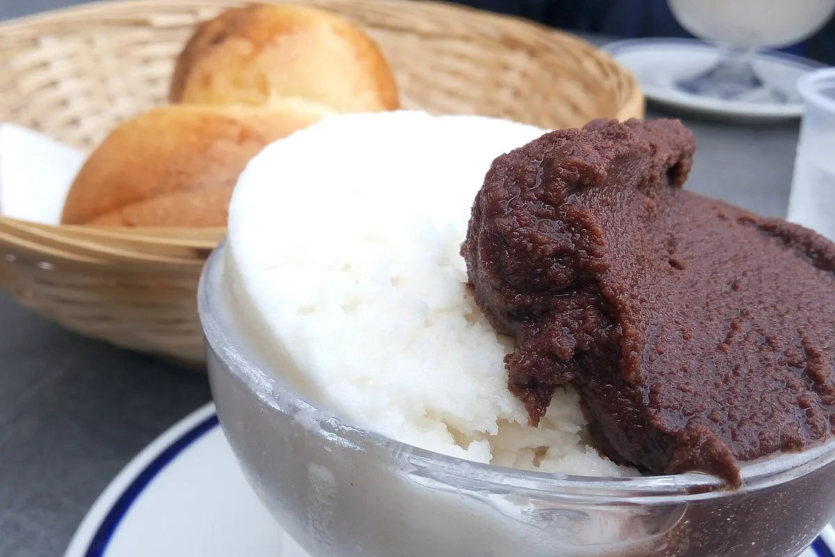 A granita with a warm brioche col tuppo, the Sicilian breakfast