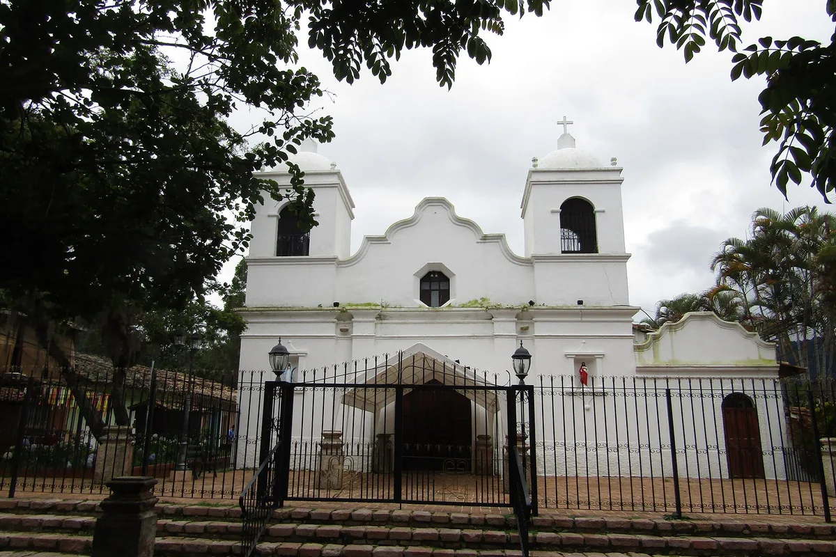 The white colonial church of Valle de Ángeles under a cloudy sky