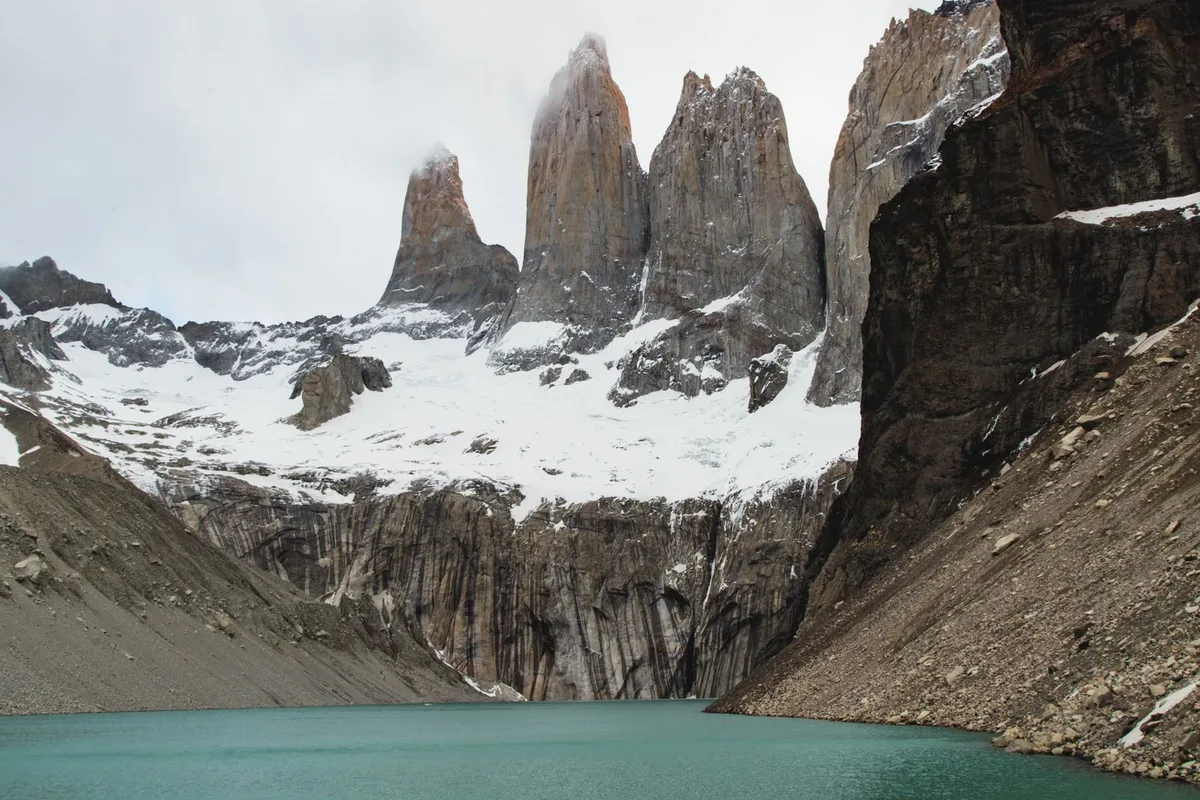 The three granite towers above their moraine lake at the end of the Base Torres trail