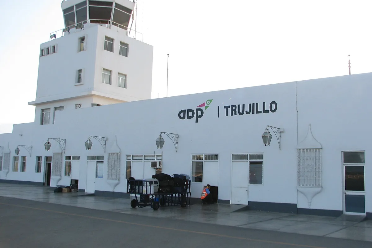 The white terminal and control tower of Trujillo's Pinillos Airport, with the ADP Trujillo sign on the facade
