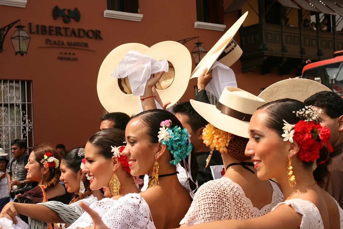 Marinera dancers in white dresses and wide hats at a Trujillo festival