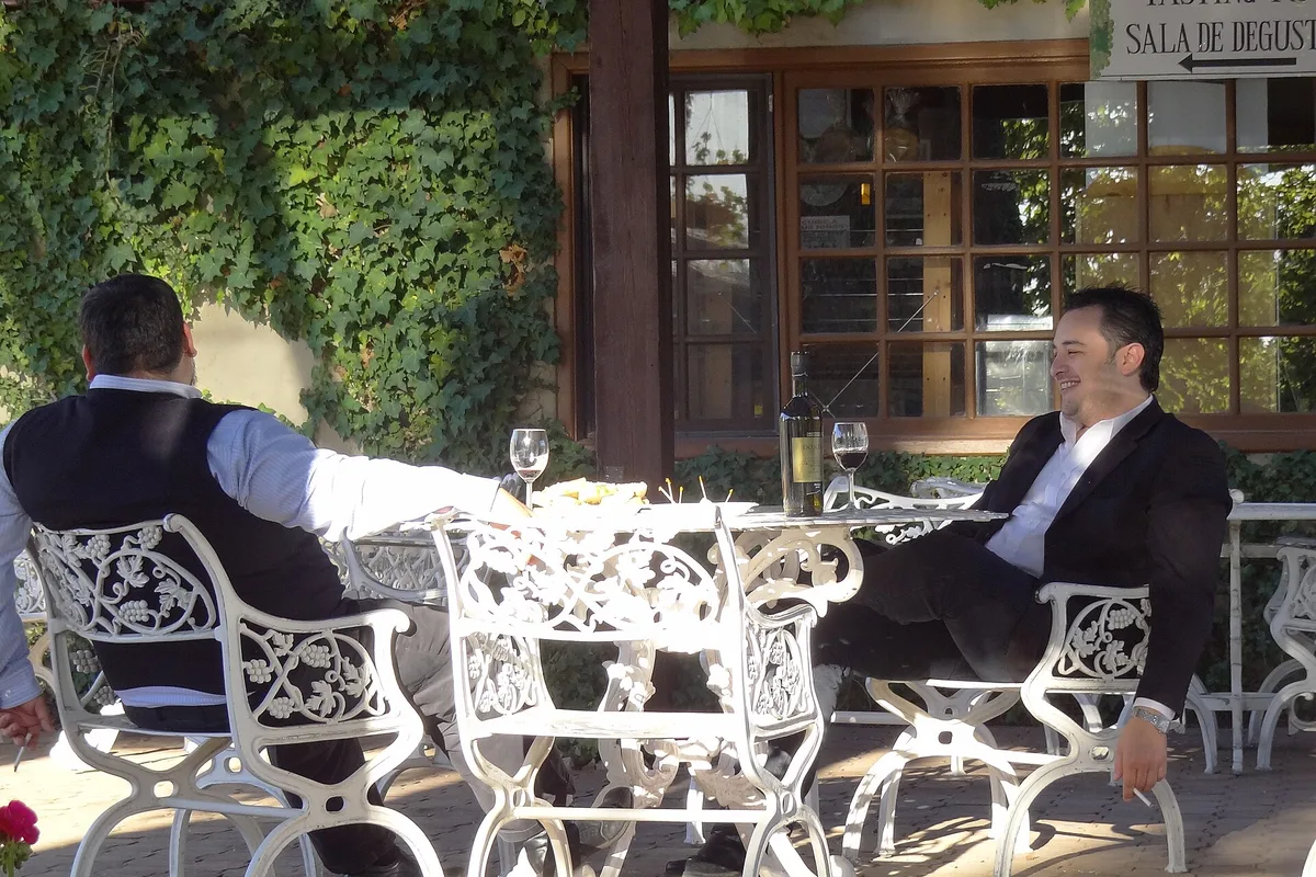The tasting terrace at L.A. Cetto winery, tables under the pergola in Valle de Guadalupe