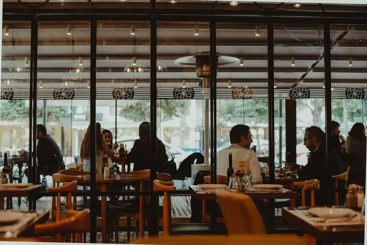 Diners at the tables of a glass-fronted campestre restaurant in the valley
