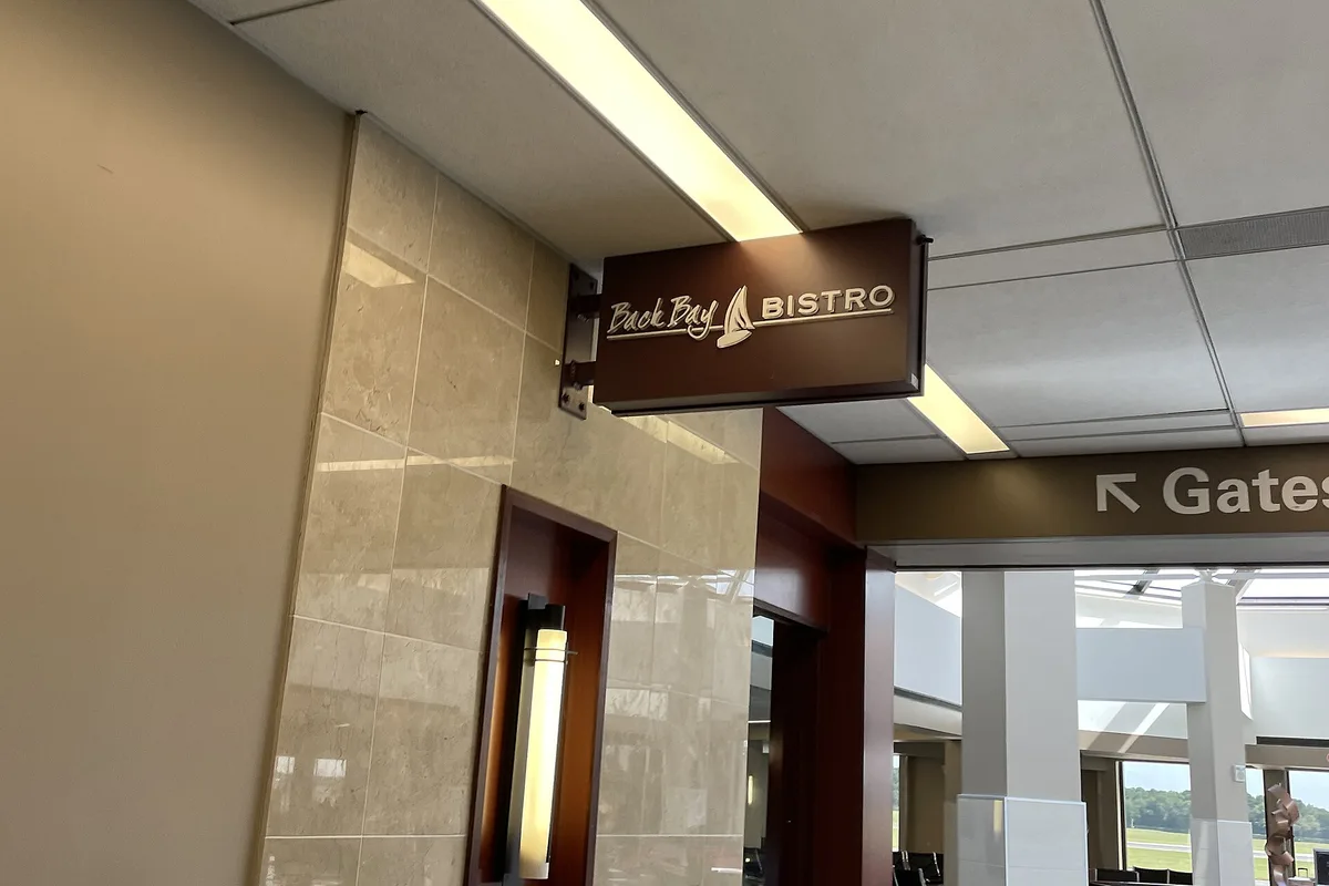 Inside Norfolk International Airport, the Back Bay Bistro sign beside the corridor to the gates