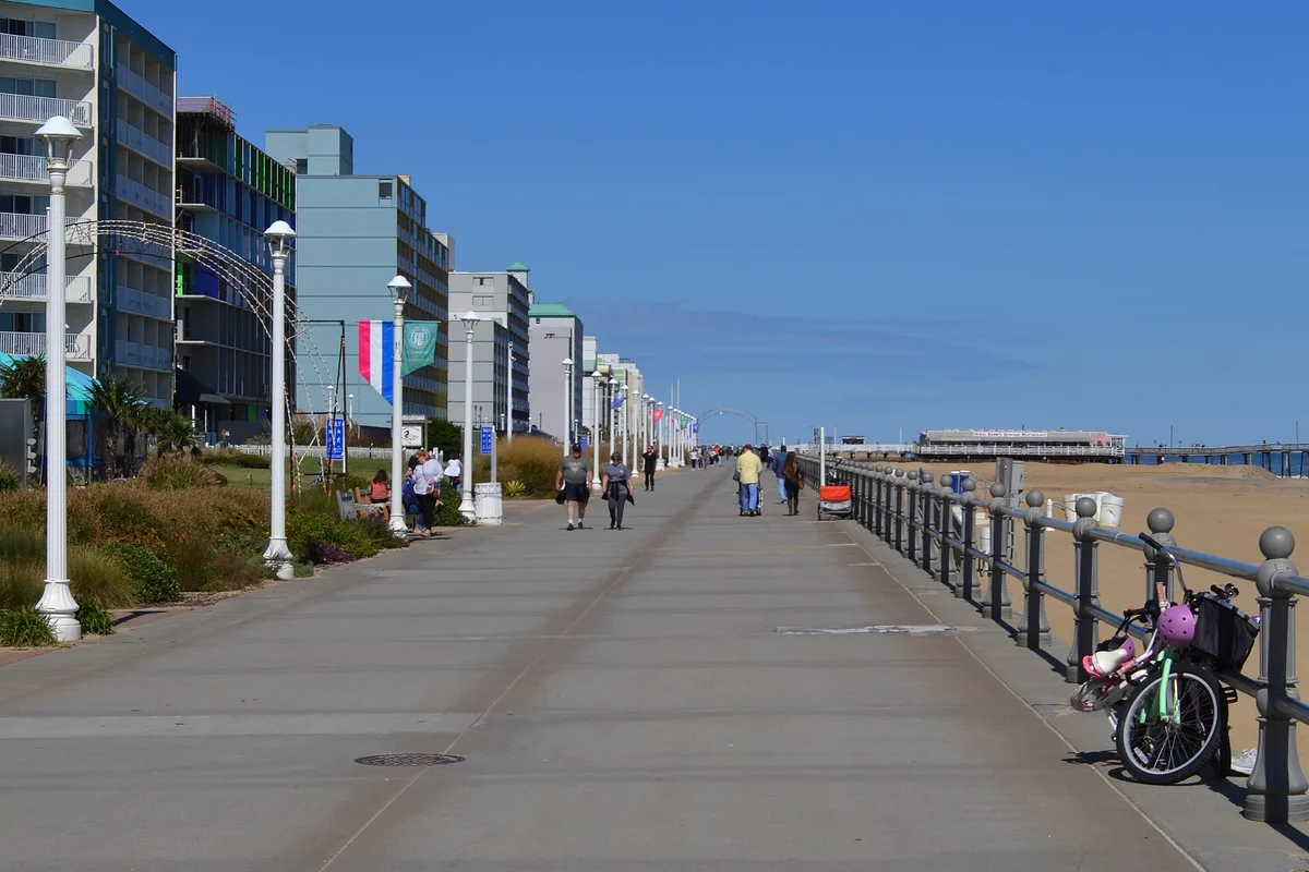 The Virginia Beach boardwalk stretching toward the fishing pier, hotels on one side and the beach on the other