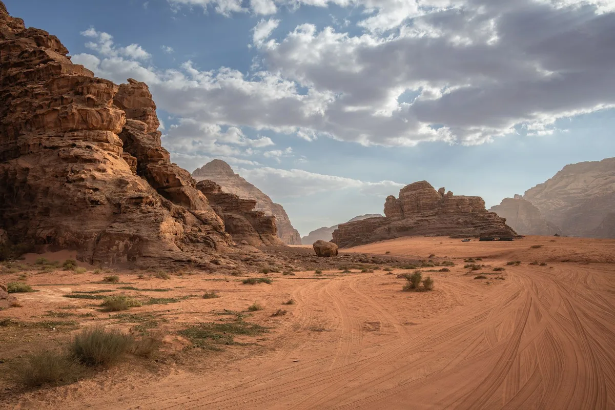 The desert road running through the rock towers of Wadi Rum